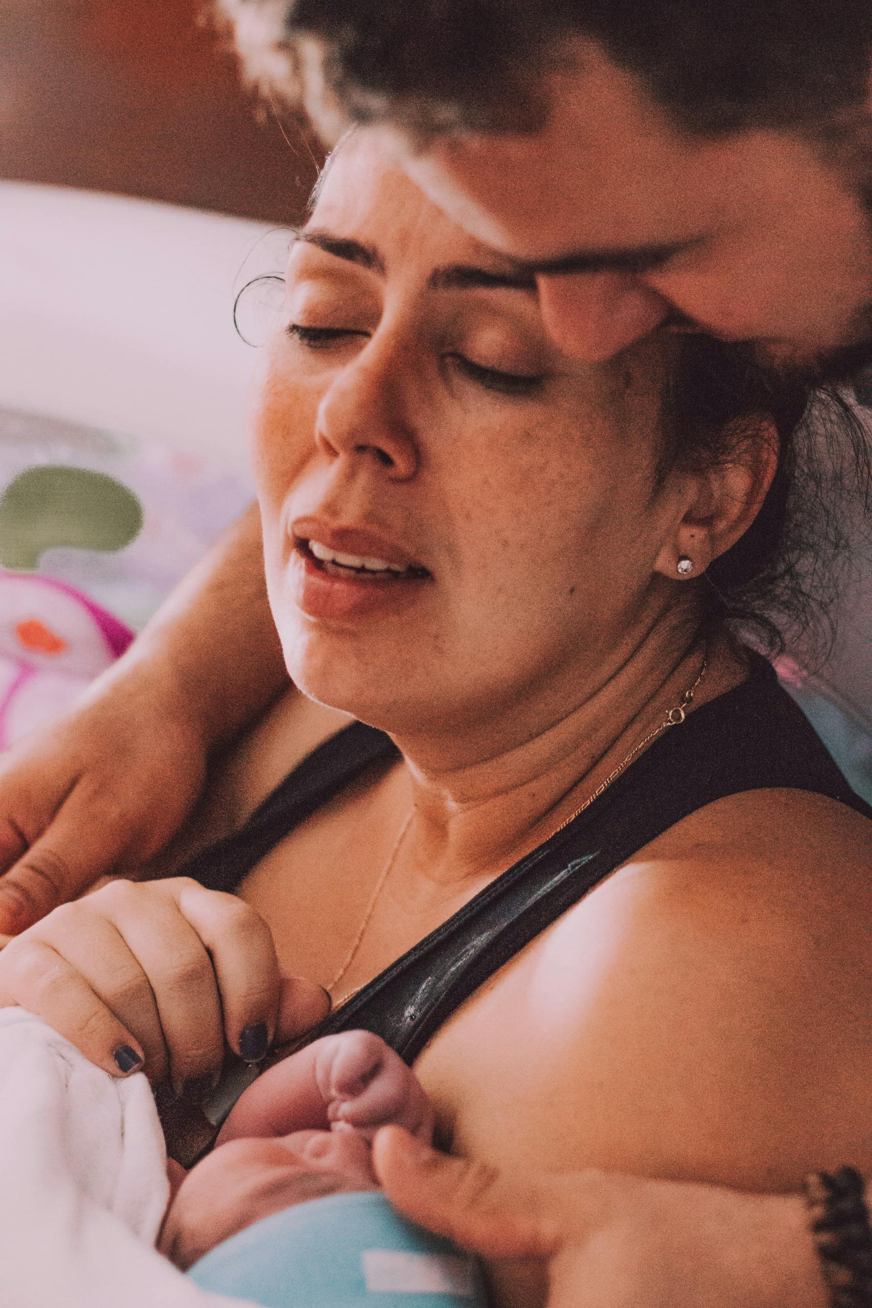 Intimate moment of a new mother and baby right after birth, capturing pure emotion.
